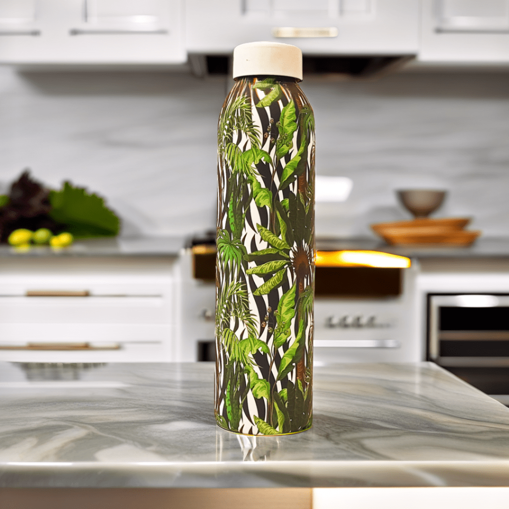 A white water bottle with a black and white zebra print and green and white tropical leaves.