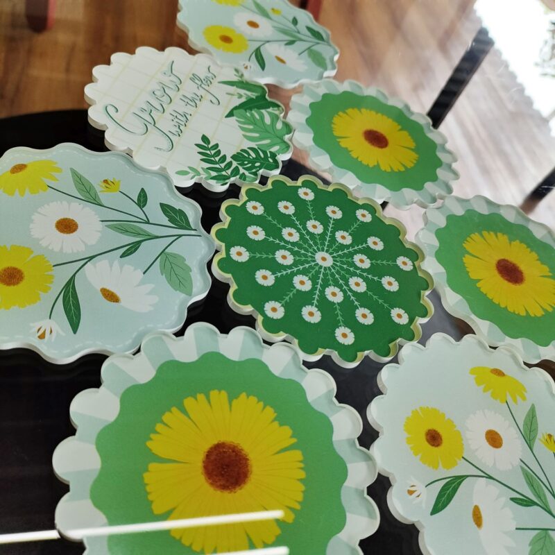 yellow flower design printed on Acrylic Material and this is a Coaster.