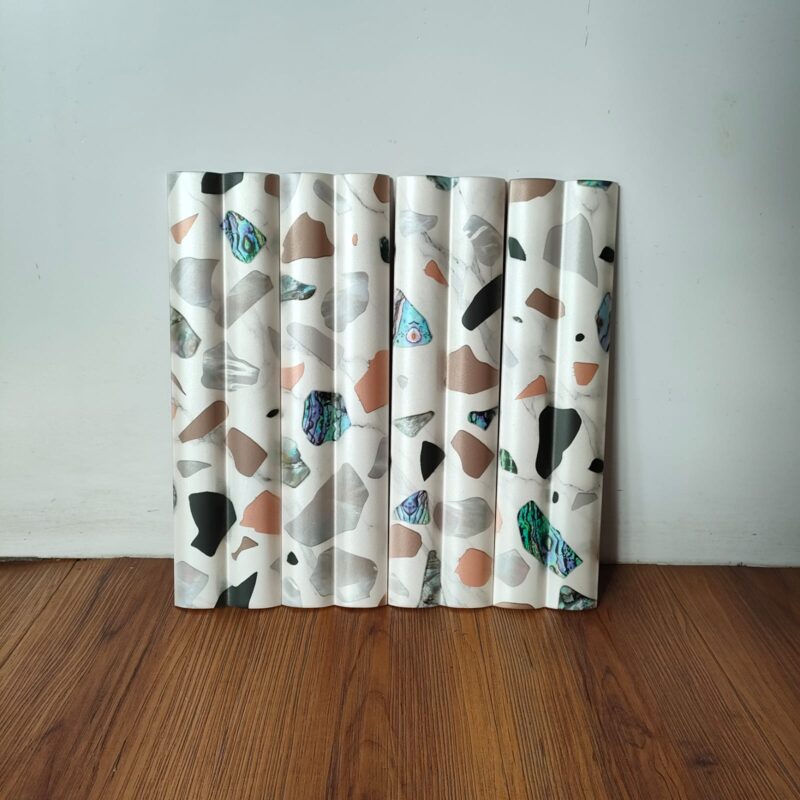 Row of curved terrazzo tiles with a mix of white, black, gray, and brown chips.