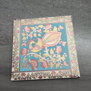 Square ceramic tile with Kalamkari peacock design.