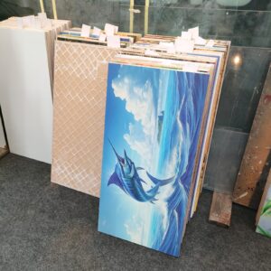 Assortment of ceramic tiles with various designs, including a prominent marlin image.