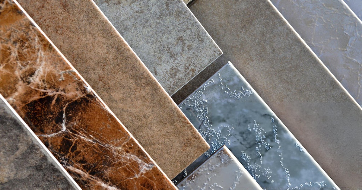 Assortment of ceramic tiles in various shades of brown, gray, and beige with different textures and finishes.