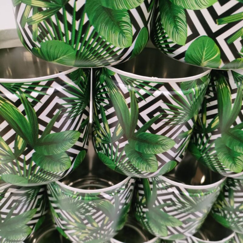 A close-up image of several round steel containers stacked on top of each other and the beauty of nature printed on it. this is a UV Digital Printing