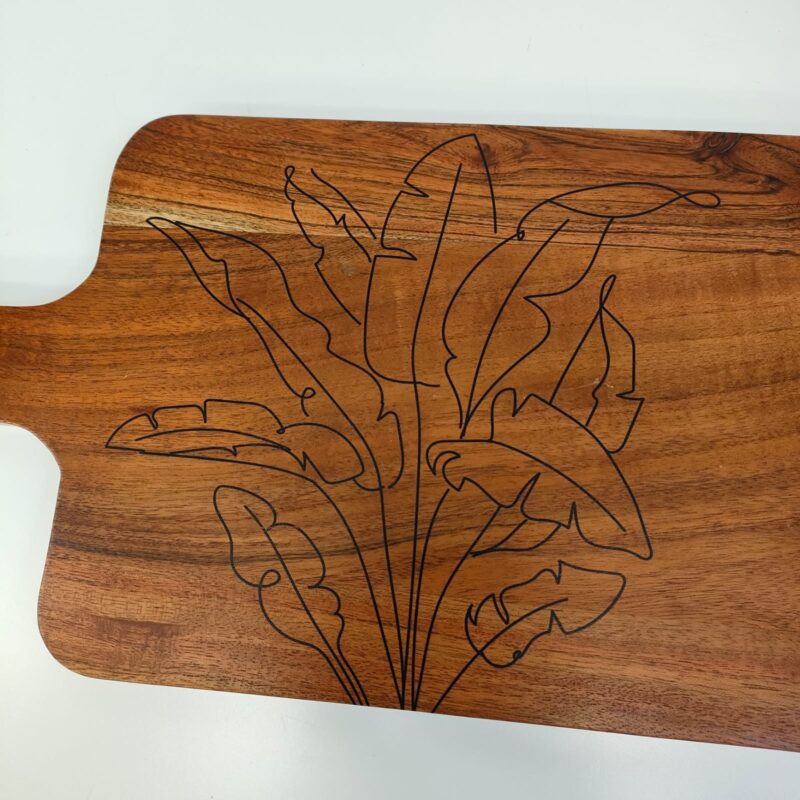 Rectangular wooden serving board with engraved printed leaf pattern.