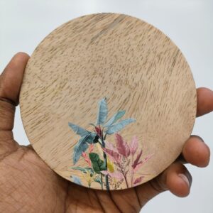Round wooden coaster with a colorful tropical floral print.