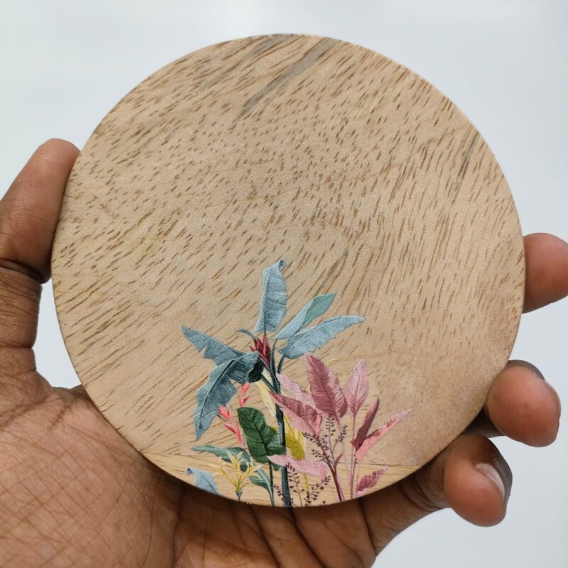 Round wooden coaster with a colorful tropical floral print.