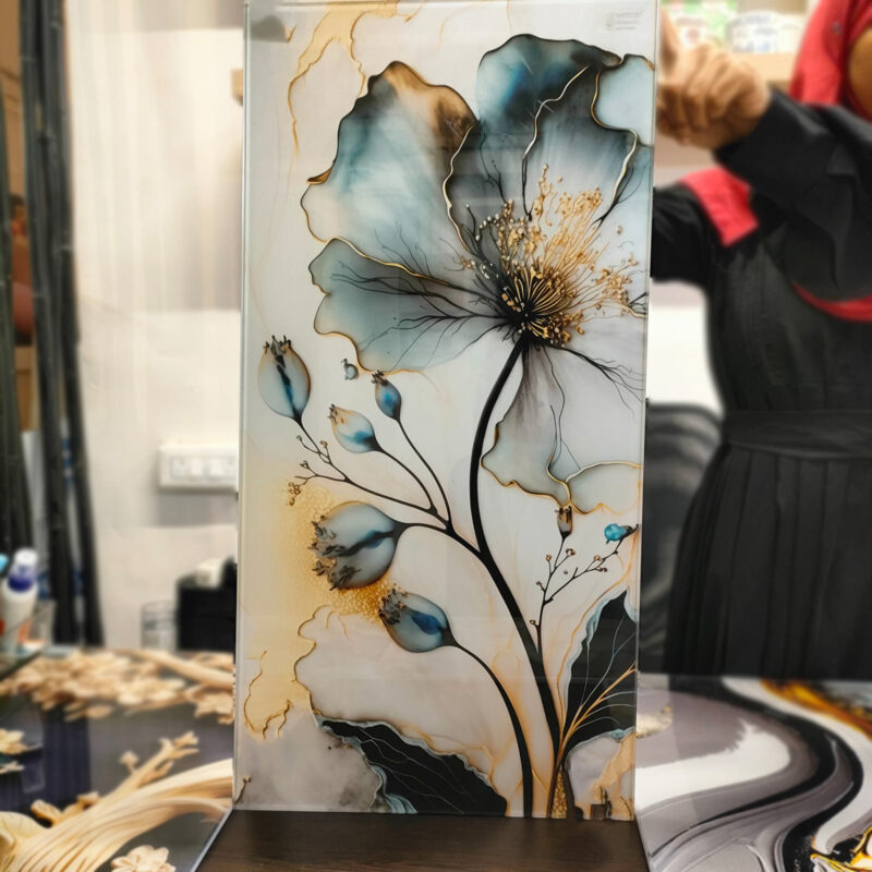 A vibrant floral print featuring a large, blue flower with golden accents, directly printed on glass.